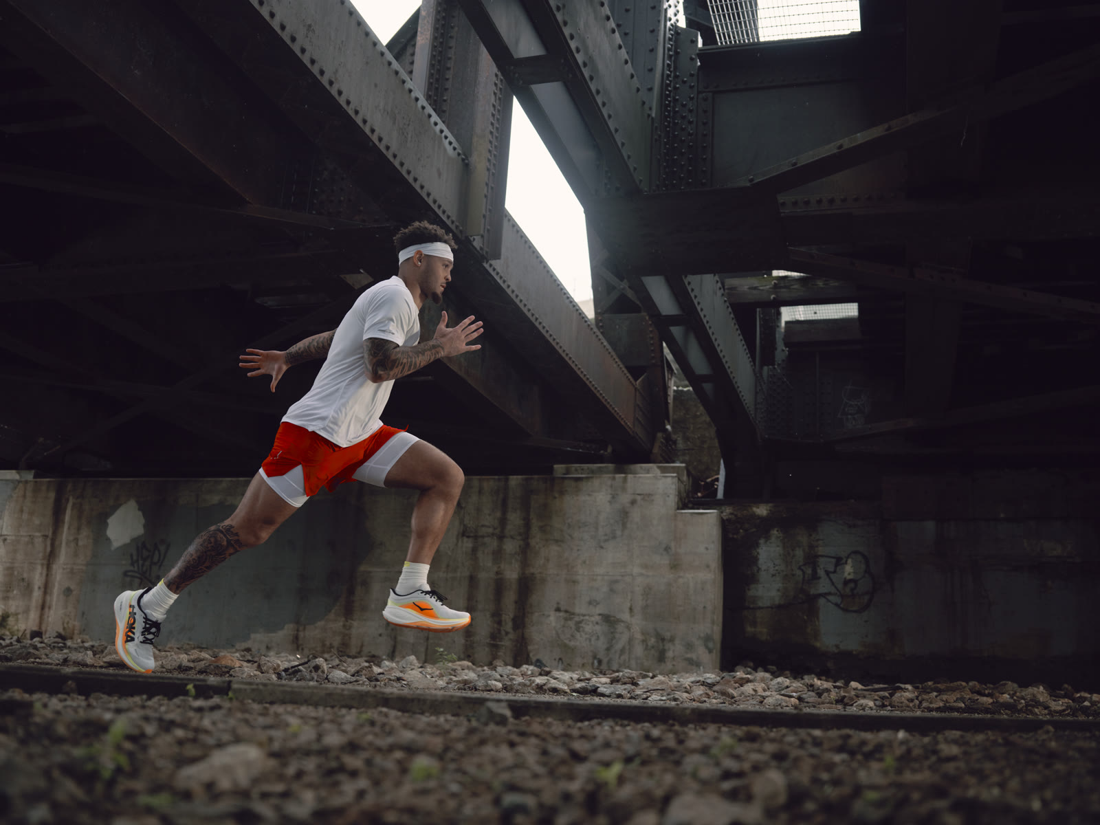 Brandon Inniss runs under a graffiti-covered railway bridge along the Scioto Mile.